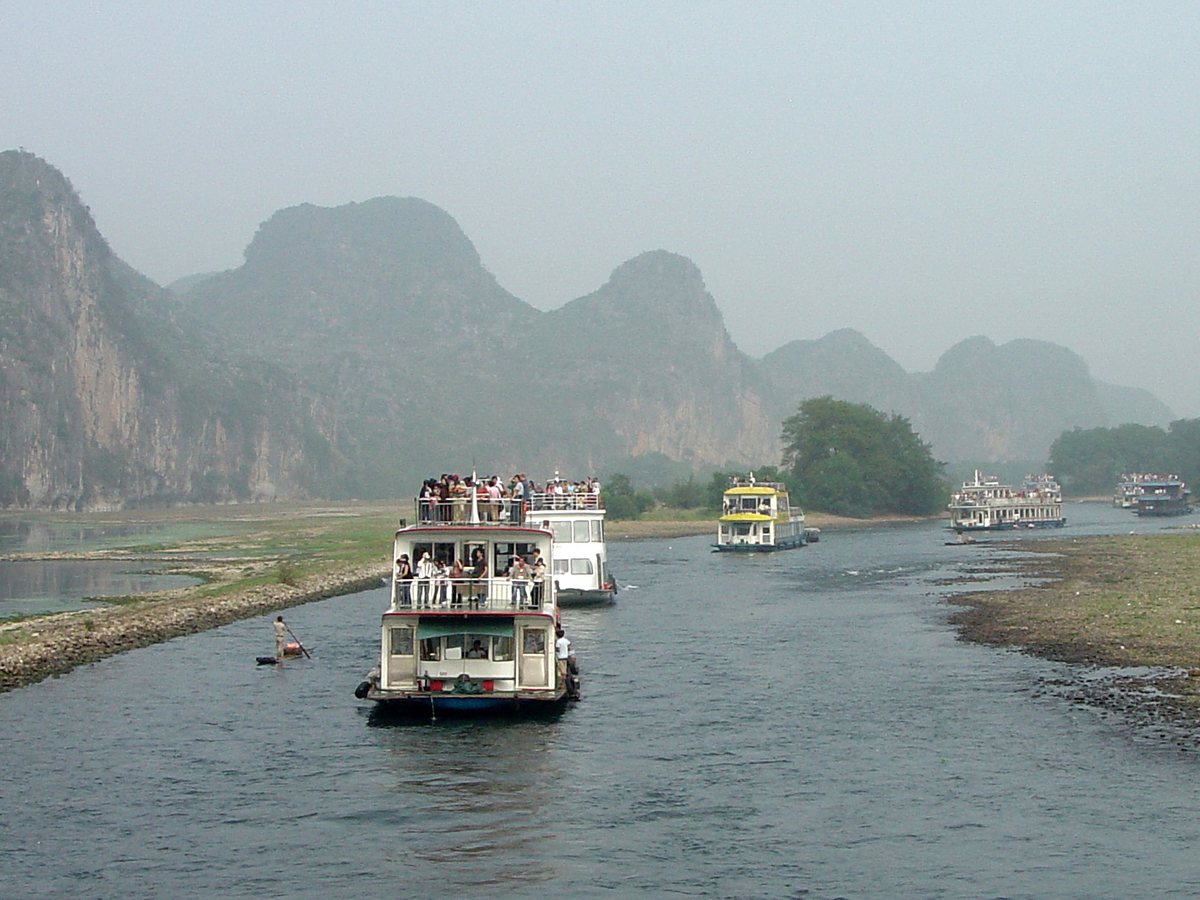 Cruise boats on the Li River beneath Guilin's karst mountains