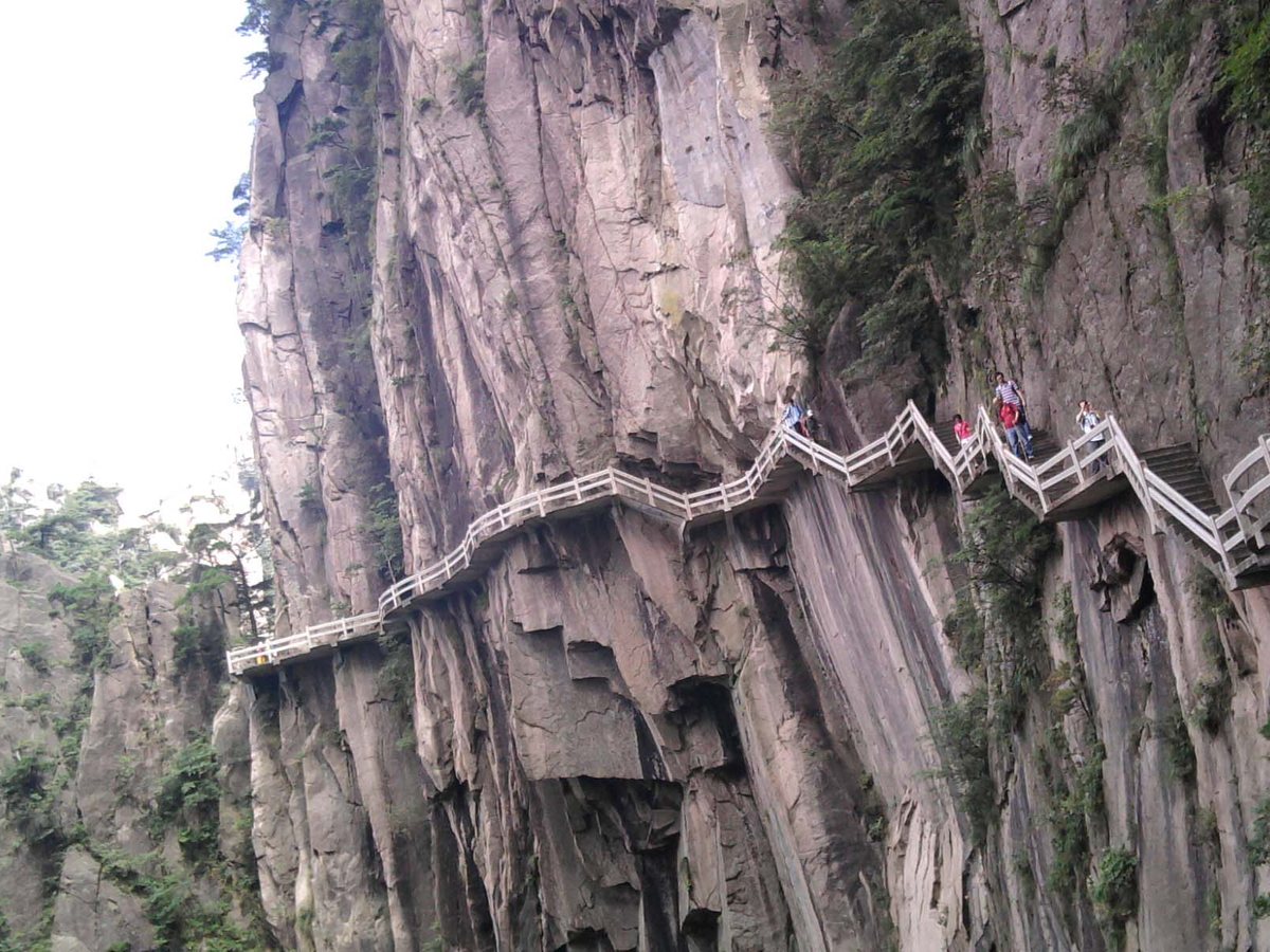 Cliffside stone steps among granite peaks and pine trees on Huangshan