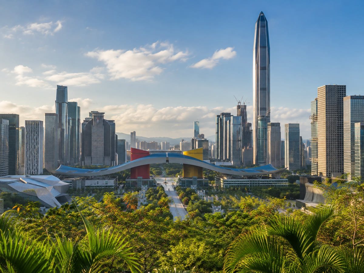 Shenzhen's Futian skyline beyond a subtropical civic park