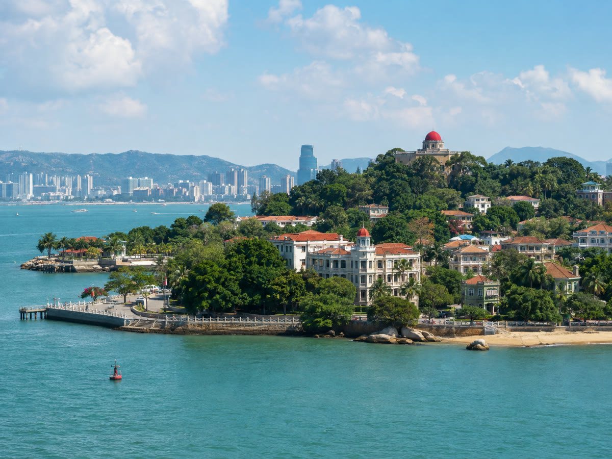 Gulangyu Island's green waterfront and red-roofed villas across the water in Xiamen