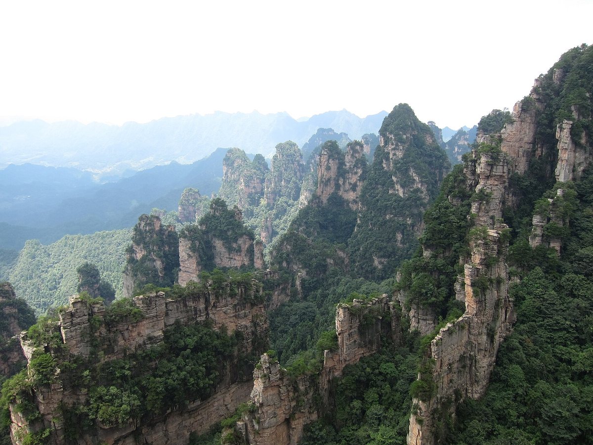 Quartz sandstone pillars rising through mist in Zhangjiajie